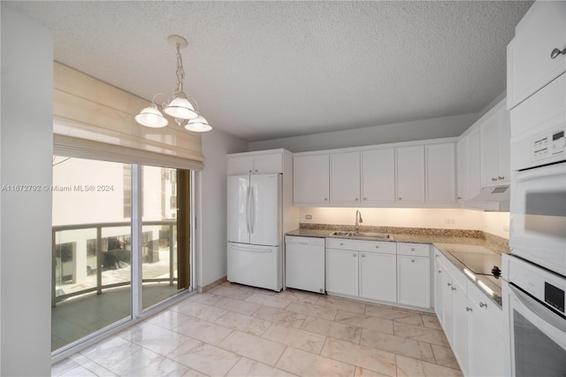 8855 Collins Ave Unit 2D, Surfside, FL 33154 - kitchen with white appliances, a sink, under cabinet range hood, light marble finish floors, and a chandelier