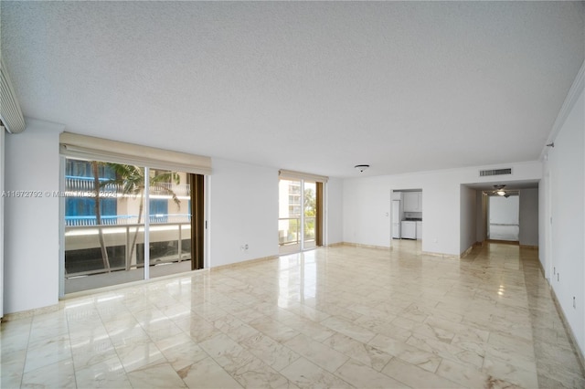 8855 Collins Ave Unit 2D, Surfside, FL 33154 - empty room with light marble finish flooring, a textured ceiling, and baseboards