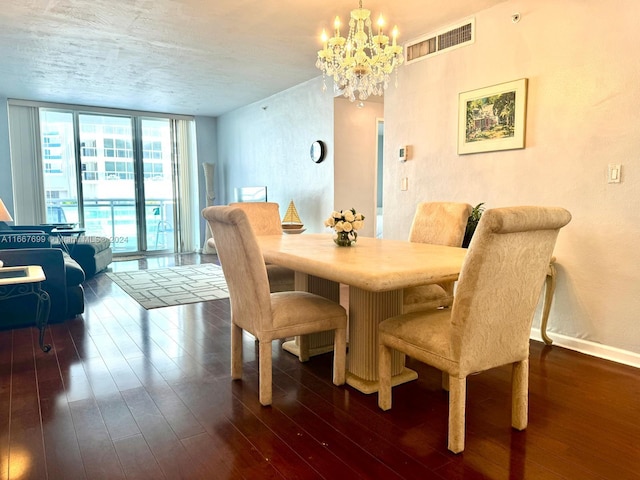 dining space featuring a chandelier, expansive windows, and dark wood-type flooring