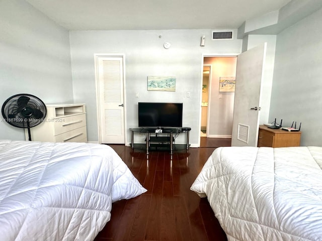 bedroom with dark hardwood / wood-style flooring