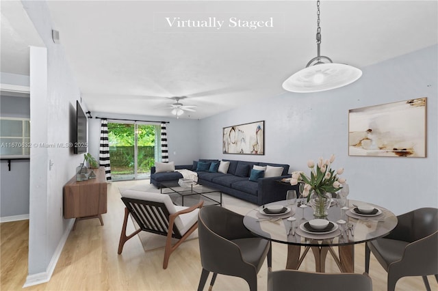 living room featuring ceiling fan and light hardwood / wood-style flooring