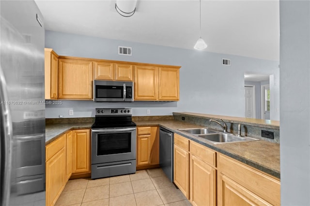 kitchen featuring pendant lighting, light tile patterned floors, sink, and appliances with stainless steel finishes