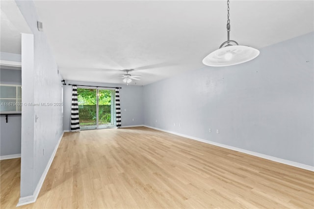 empty room featuring light hardwood / wood-style flooring and ceiling fan