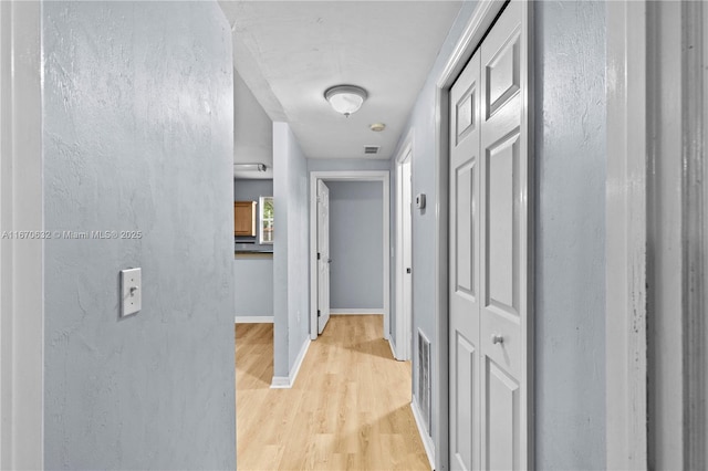 hallway with light wood-type flooring