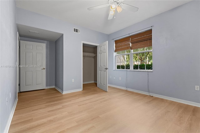 unfurnished bedroom featuring ceiling fan, a closet, and light hardwood / wood-style flooring