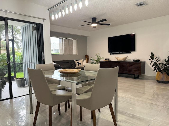 dining space featuring a textured ceiling, plenty of natural light, and ceiling fan