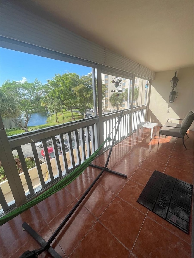 unfurnished sunroom with a water view