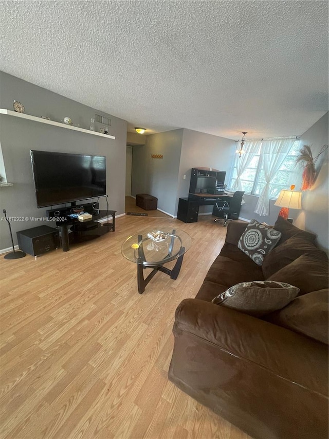 living room featuring a textured ceiling and light hardwood / wood-style floors