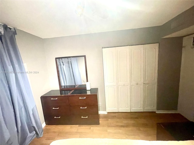 unfurnished bedroom featuring light hardwood / wood-style floors and a closet