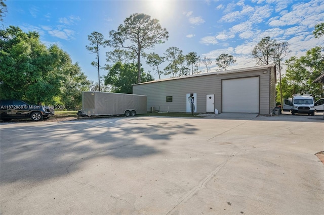 view of front facade with a garage and an outbuilding