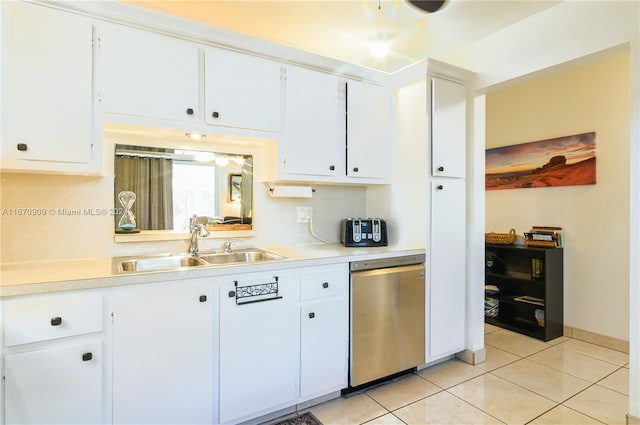 kitchen featuring light tile patterned flooring, white cabinetry, dishwasher, and sink