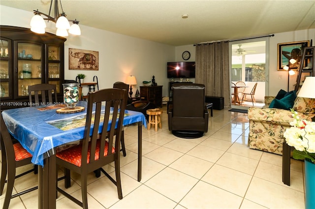 dining room with an inviting chandelier, a textured ceiling, and light tile patterned floors