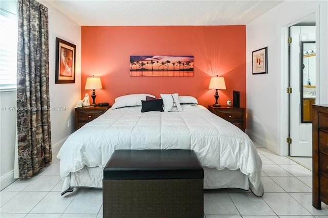 bedroom with light tile patterned flooring and a textured ceiling