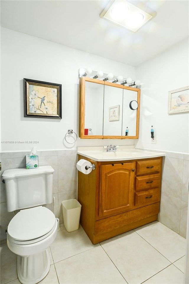 bathroom with vanity, tile walls, toilet, and tile patterned floors