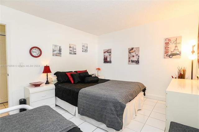 bedroom featuring light tile patterned flooring