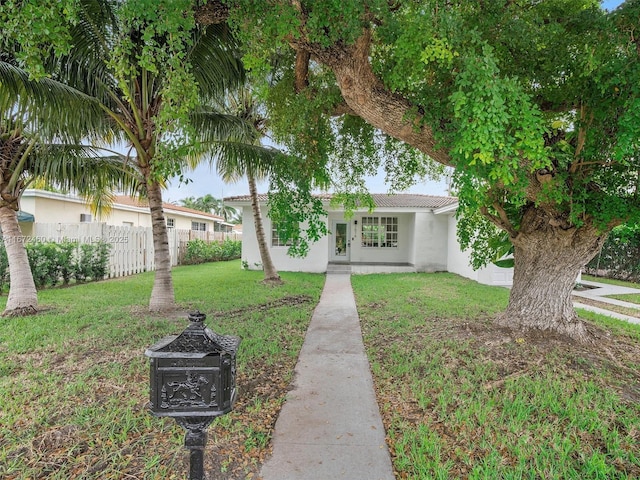 ranch-style home featuring a front yard