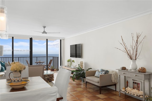 tiled dining room with a wall of windows, ornamental molding, and a water view