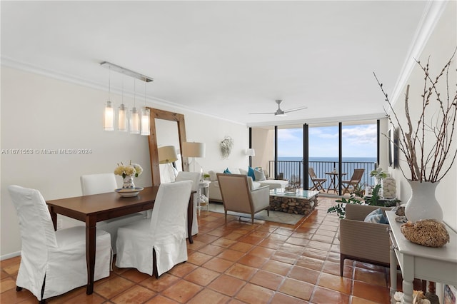 dining space featuring ceiling fan, ornamental molding, a wall of windows, tile patterned flooring, and a water view