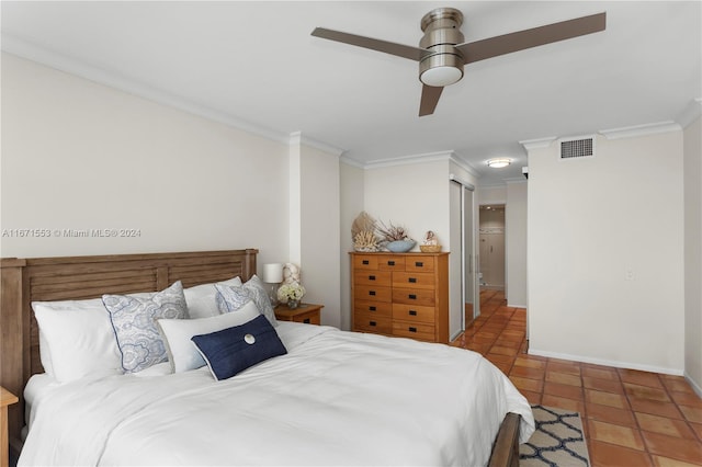 bedroom featuring ornamental molding, connected bathroom, tile patterned flooring, and ceiling fan