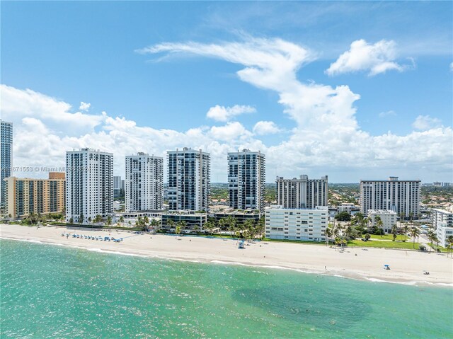 birds eye view of property with a beach view and a water view