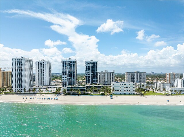 birds eye view of property with a view of the beach and a water view