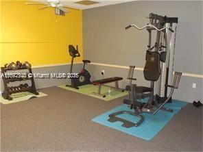 exercise area featuring carpet flooring and ceiling fan