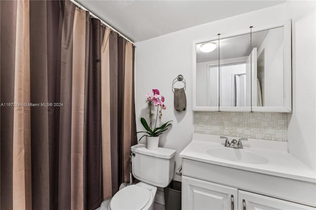 bathroom featuring vanity, a shower with curtain, tasteful backsplash, and toilet