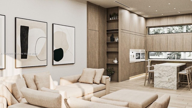 living room featuring light hardwood / wood-style flooring, built in shelves, a high ceiling, and wooden walls