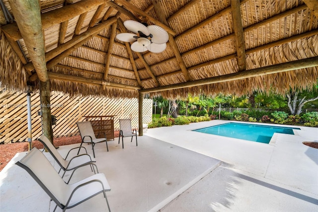 view of pool with a gazebo, ceiling fan, and a patio area