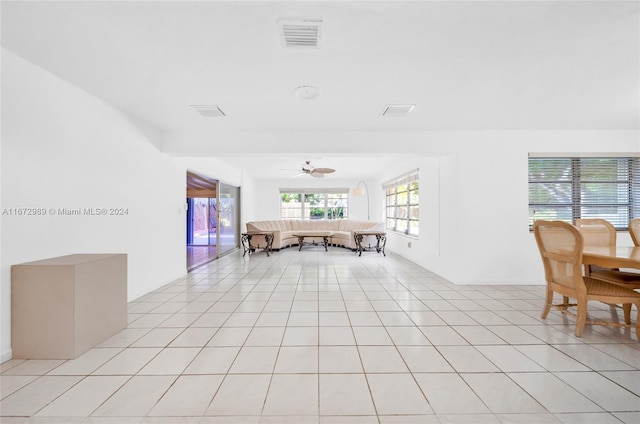 dining area featuring ceiling fan and light tile patterned floors