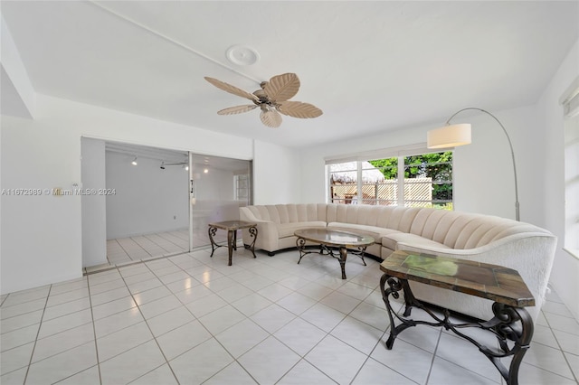 living room with ceiling fan and light tile patterned floors