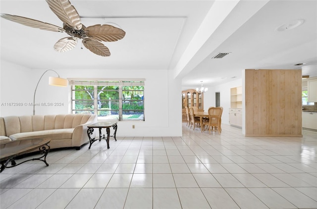 living room featuring ceiling fan with notable chandelier and light tile patterned floors