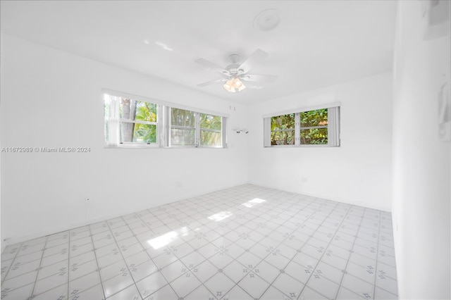 spare room featuring ceiling fan and plenty of natural light