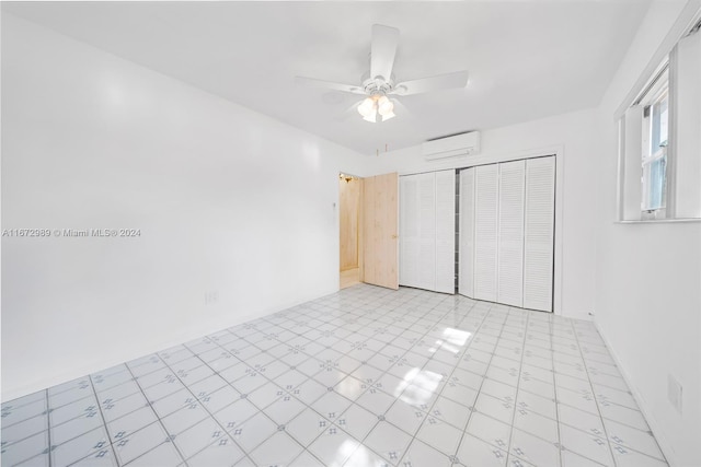 unfurnished bedroom featuring ceiling fan, a wall unit AC, and a closet