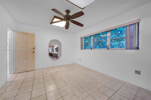 unfurnished room featuring ceiling fan and light tile patterned floors