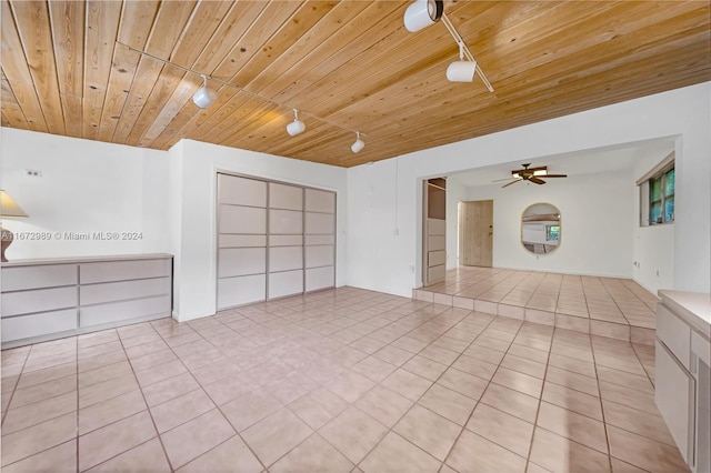 spare room with ceiling fan, wood ceiling, and light tile patterned floors