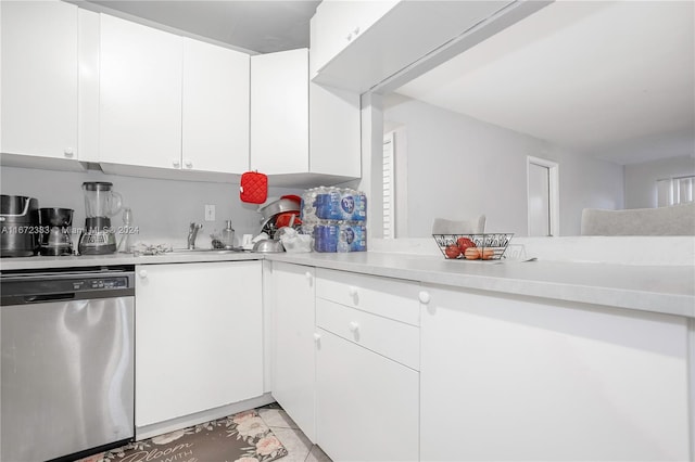 kitchen with dishwasher, white cabinetry, light tile patterned flooring, and sink