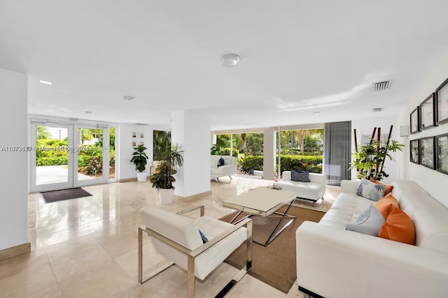 living room featuring french doors and light tile patterned floors