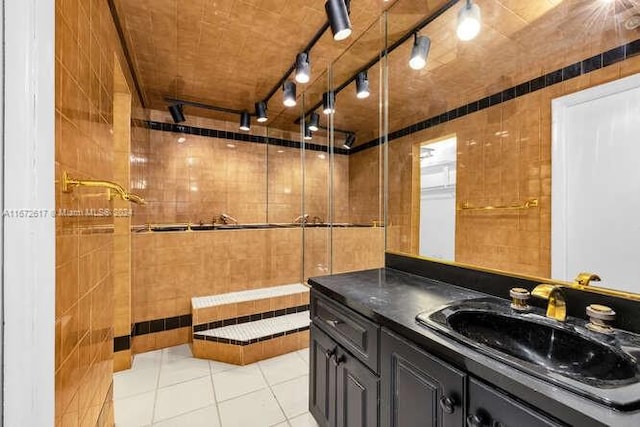 bathroom featuring walk in shower, tile walls, tile patterned flooring, and vanity