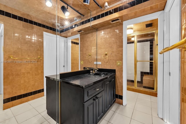 bathroom featuring tile walls, tile patterned floors, and vanity