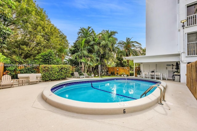 view of swimming pool with a patio area