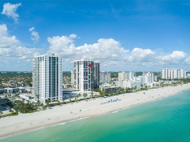 drone / aerial view featuring a view of the beach and a water view