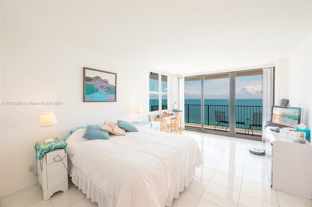 bedroom featuring light tile patterned floors, access to outside, and expansive windows