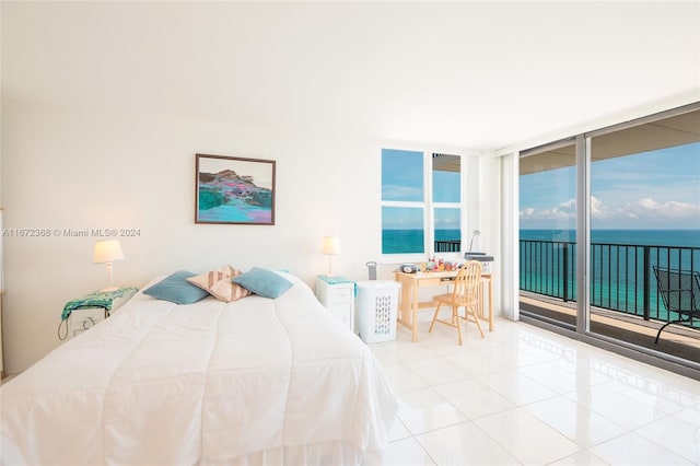 tiled bedroom featuring floor to ceiling windows, access to exterior, and a water view