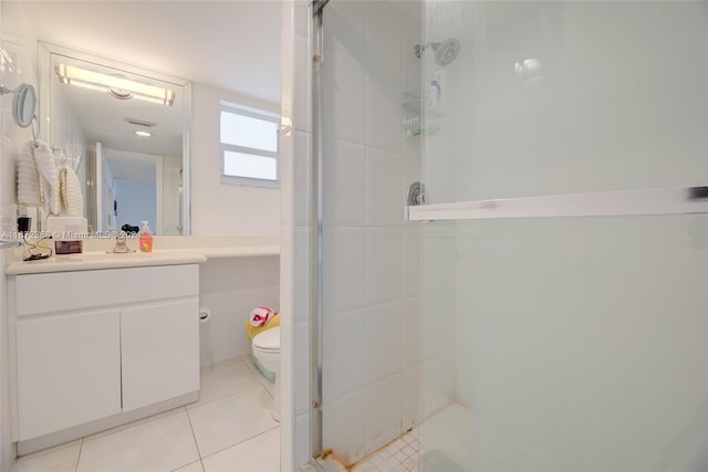 bathroom featuring tile patterned floors, vanity, toilet, and walk in shower