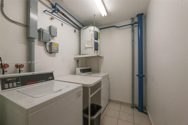 laundry area with separate washer and dryer, a textured ceiling, light tile patterned floors, and water heater