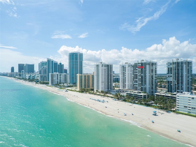 bird's eye view featuring a water view and a view of the beach