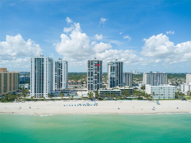 drone / aerial view featuring a beach view and a water view