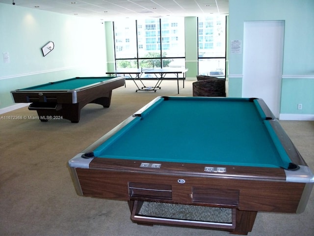 recreation room featuring light carpet, billiards, and a wall of windows