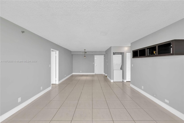 unfurnished living room with a textured ceiling and light tile patterned floors